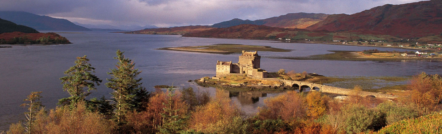 Panoramic view of Eilean Donan Castle with Loch Alsh in the background